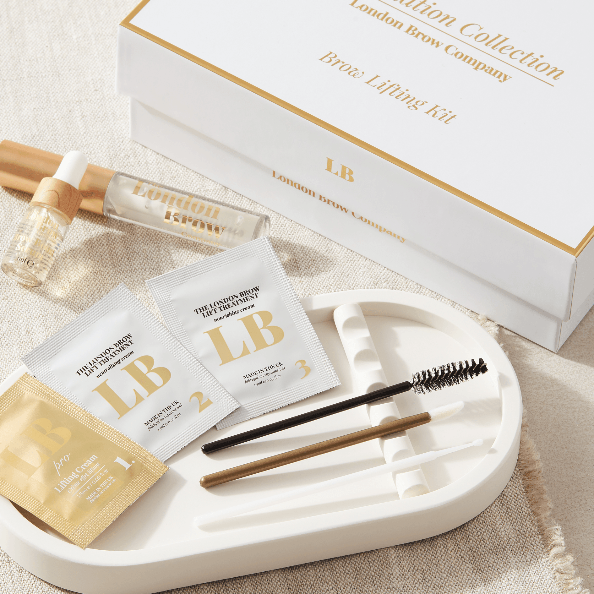 Eyebrow care kit with 'London Brow Collection' branding on a beige surface.