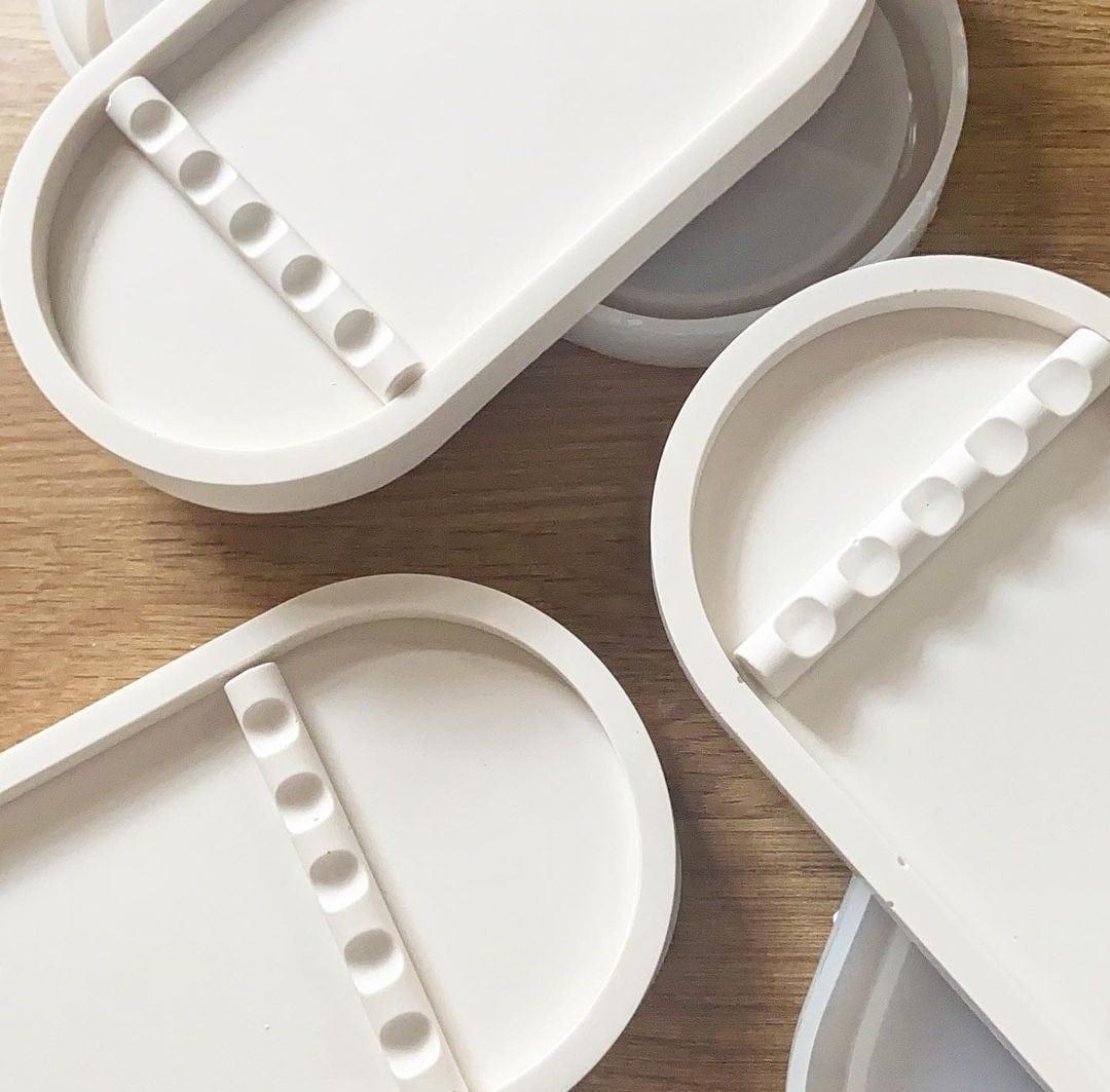White ceramic trays with decorative elements on a wooden surface