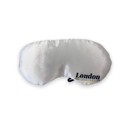 White eye mask with 'London Brow Doctor' branding on a white background