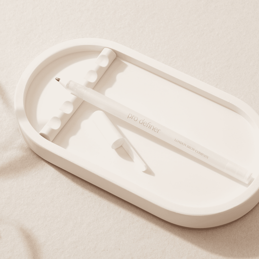 white eyebrow mapping pen from london beauty company on a jesmonite tray