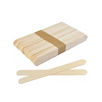 Box of wooden popsicle sticks with two sticks laid out in front on a white background